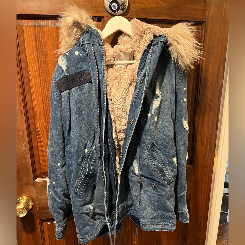 Distressed Denim winter jacket with pink faux fur lining and hood.